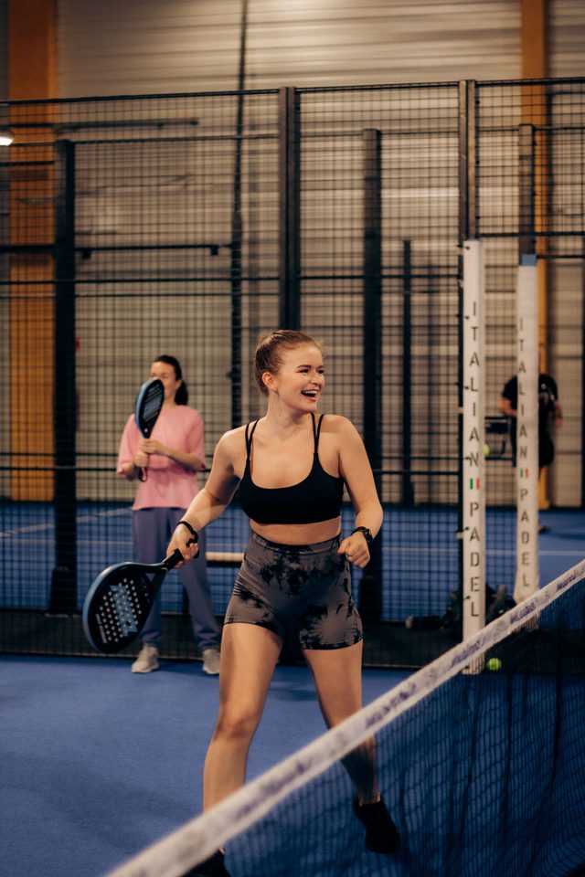 Two players laughing at the net